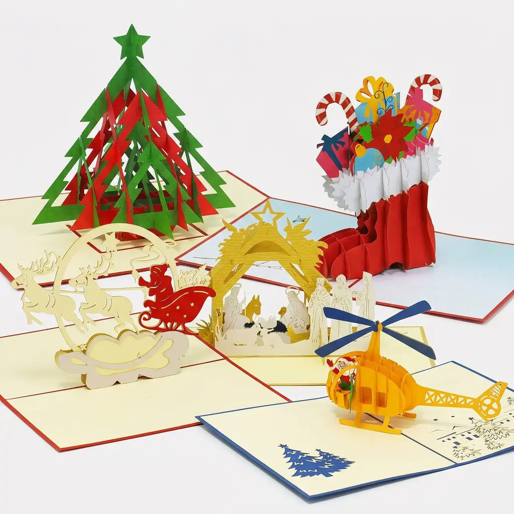 Fünf geöffnete LINPopUp Pop-Up-Weihnachtskarten: moderner Tannenbaum, gefüllter Nikolausstiefel, Weihnachtsmann im Rentierschlitten, Weihnachtskrippe und gelber Helikopter mit Weihnachtsmann